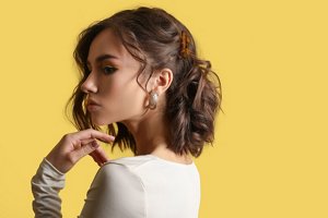 Brunette girl with a half up, half down prom hairstyle